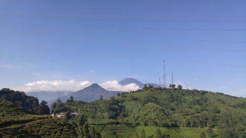 Scenic view of mountains against blue sky