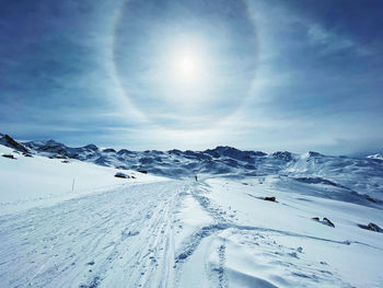 Scenic view of snow covered landscape against sky