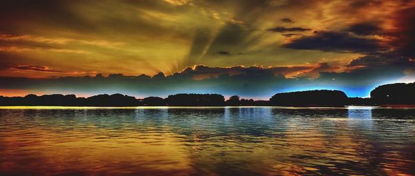 Scenic view of lake against sky during sunset