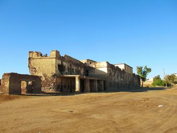 Old buildings against clear blue sky