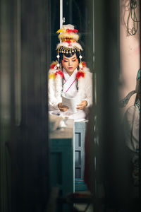Portrait of woman seen through glass window
