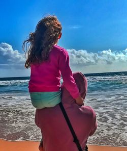 Woman at beach against sky