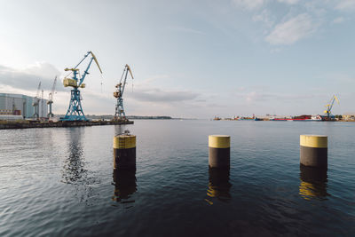 Commercial dock by sea against sky