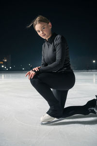 Full length of young woman standing on snow