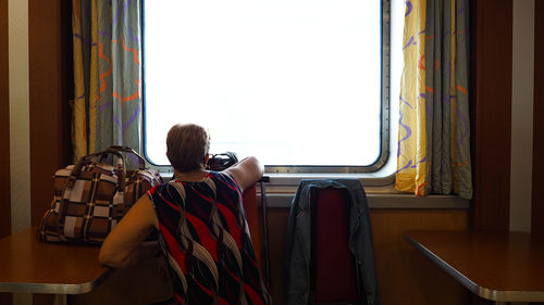 Rear view of man sitting on seat at home
