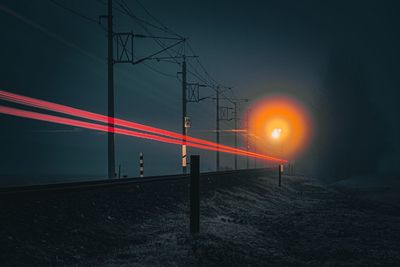 Illuminated bridge against sky during sunset