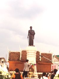 Statue of people in front of built structure