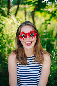 Portrait of smiling young woman wearing prop