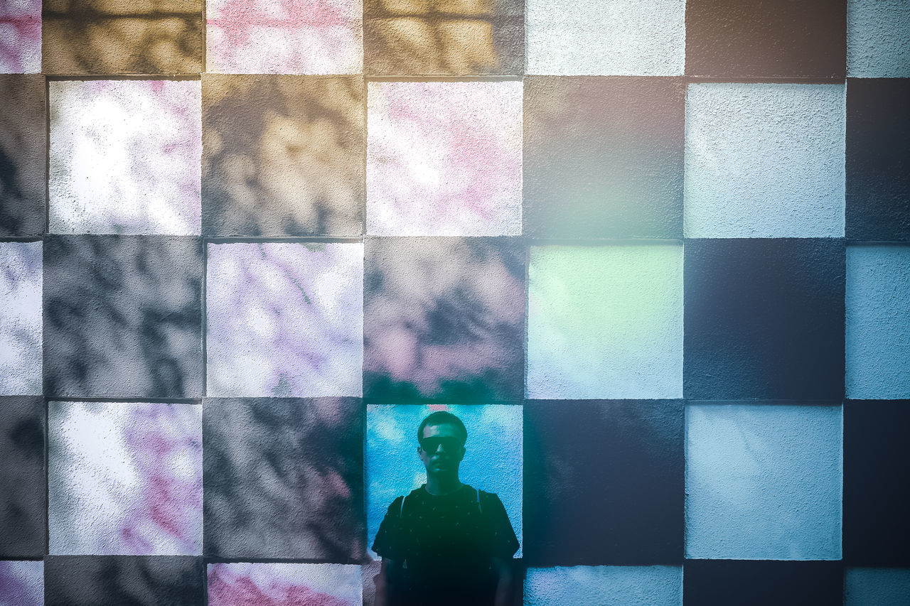 DIGITAL COMPOSITE IMAGE OF MAN WITH MULTI COLORED PATTERN