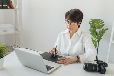 Female doctor using laptop at home