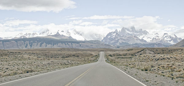 Empty road with mountains in background