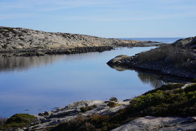 Scenic view of lake against clear blue sky