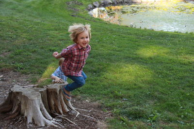 Happy boy playing in field