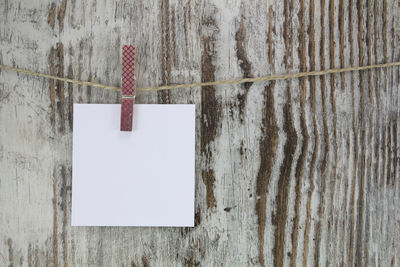 Close-up of paper hanging on wall