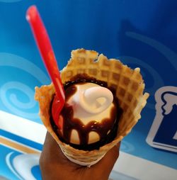 Close-up of hand holding ice cream