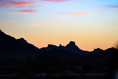 Scenic view of silhouette mountains against sky at sunset