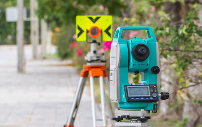 Close-up of total station equipment on road