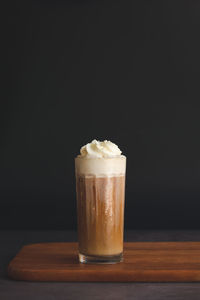 Close-up of coffee on table against black background