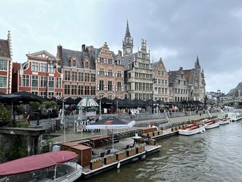 Buildings in city against cloudy sky