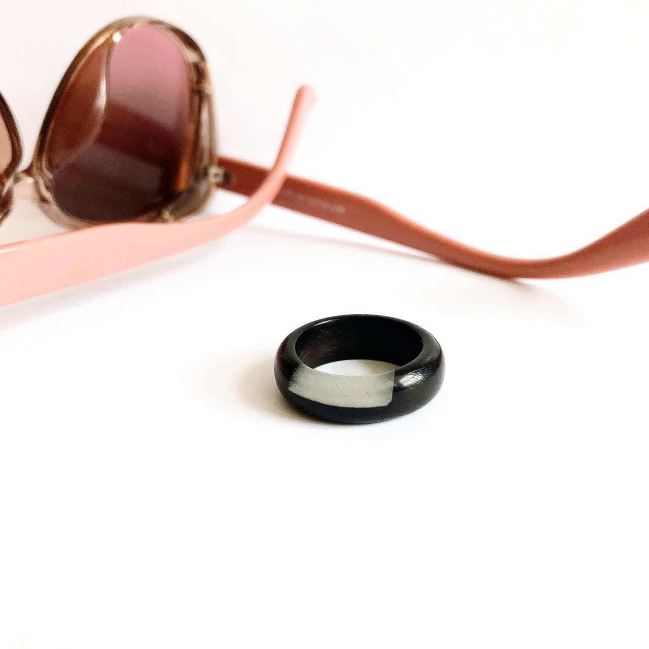 CLOSE-UP OF SUNGLASSES ON TABLE