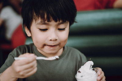 Close-up portrait of boy holding baby