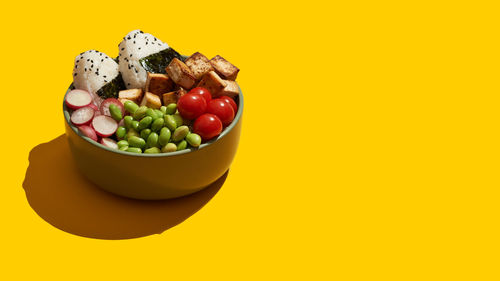 Vegan bowl with onigiri, tofu and vegetables