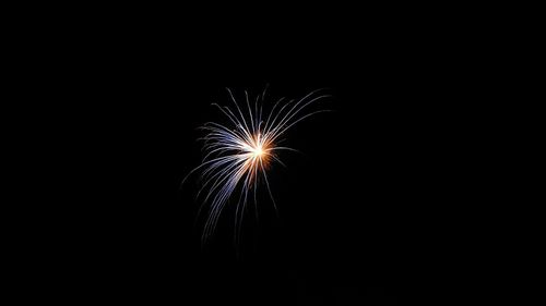 Low angle view of firework display at night