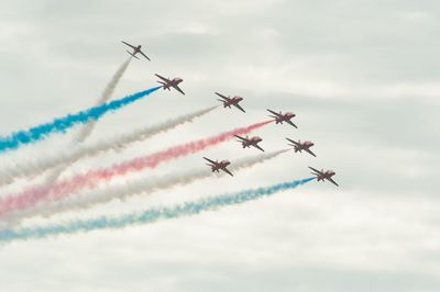 Low angle view of airshow in sky