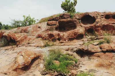 Low angle view of rock formations against sky