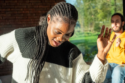 Side view of young man using mobile phone