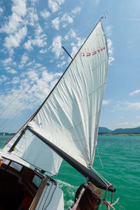 Sailboat sailing in sea against sky