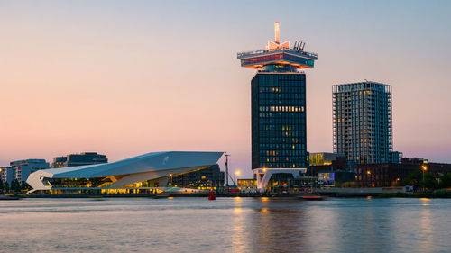 Illuminated city at waterfront