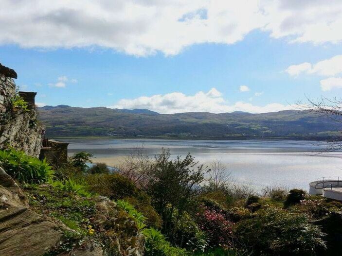 SCENIC VIEW OF LAKE WITH MOUNTAINS IN BACKGROUND