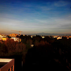 Silhouette cityscape against sky during sunset