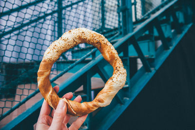 Close-up of a hand holding pretzel