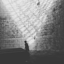 Silhouette man walking in corridor of building