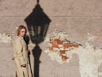 Woman standing against wall