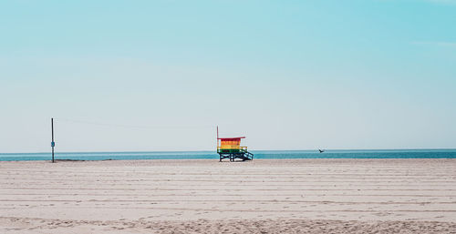 Lifeguard hut on beach against clear sky