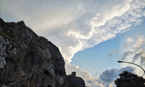 Low angle view of rock formation against sky