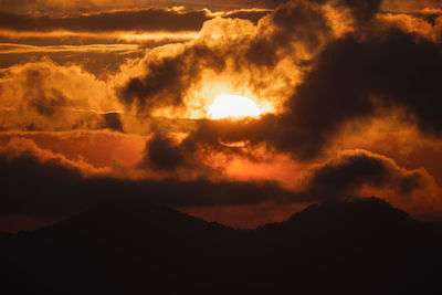 Low angle view of dramatic sky during sunset