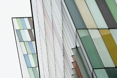 Low angle view of glass building against clear sky