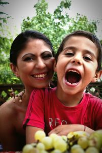 Portrait of happy woman and son with mouth open