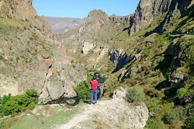 Rear view of people walking on mountain