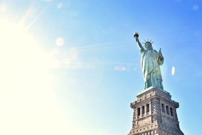 Low angle view of statue of liberty against sky