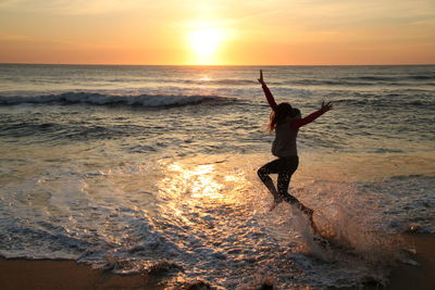 People on beach at sunset