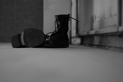 Close-up of eyeglasses on table against wall