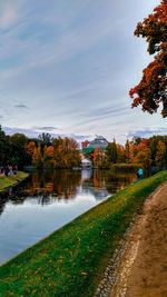 Scenic view of lake by buildings against sky