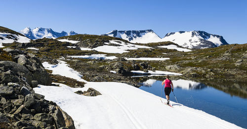 Woman cross-country skiing in mountains