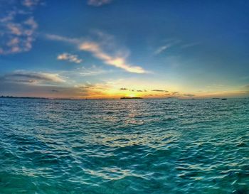 Scenic view of sea against cloudy sky