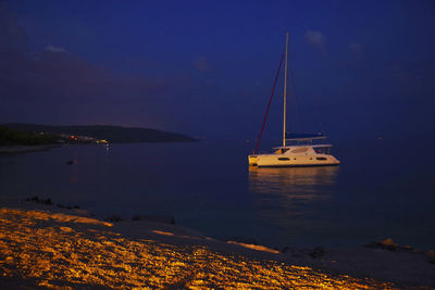 Sailboat sailing on sea against sky